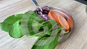 Green leaves in an iron box for making soup ingredients of Vietnamese Thai cuisine