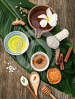 Green leaves with nature spa ingredients turmeric,herbal compress ball,dried indian bael ,cinnamon powder ,cinnamon sticks