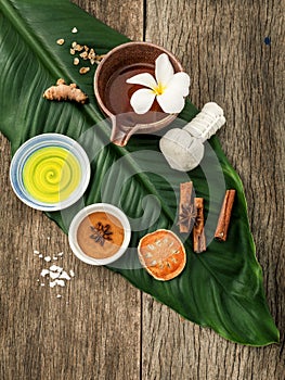 Green leaves with nature spa ingredients turmeric,herbal compress ball,dried indian bael ,cinnamon powder ,cinnamon sticks