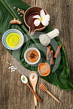 Green leaves with nature spa ingredients turmeric,herbal compress ball,dried indian bael ,cinnamon powder ,cinnamon sticks
