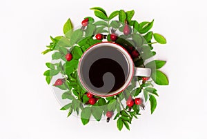 Green leaves and red berries, flowers, Cup of coffee on a white