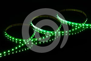 Green LED strip tape on black background