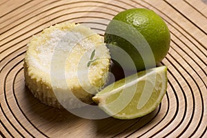 green lemon tart and mint on wooden background