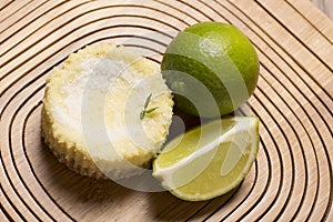 green lemon tart and mint on wooden background