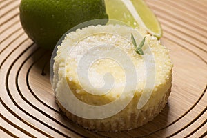 green lemon tart and mint on wooden background