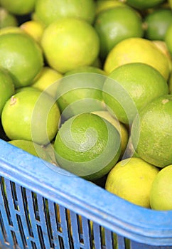 Green lemons at a fruit and vegetable market.