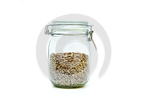 Green lentils stored inside the closable glass bottle