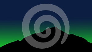 Green light behind the mountain at night