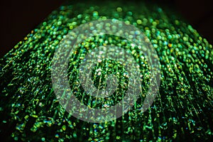 Green light passing through a stack of glass. Abstract background, bokeh