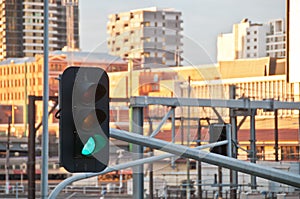 Green light traffic signal with contemporary train station background