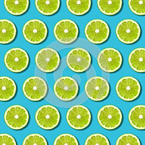 Green lime slices pattern on vibrant turquoise background
