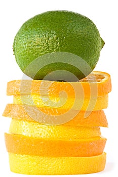 Green lime on slides of oranges and citrons. photo