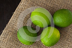 Green limes on a jute table cloth