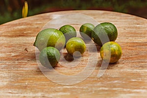Green limes on wood table