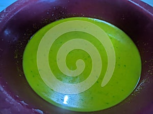 Green liquid mixture in a bowl
