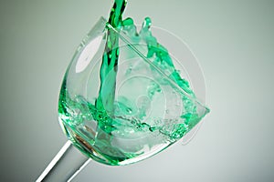 Green liquid puring in to a glass