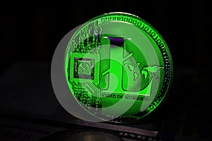 Green Litecoin LTC coin is surrounded by a gloomy background