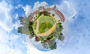 Green little planet panorama with architecture and trees, soft blue sky and white clouds. Buildings at summer. Summer.