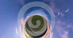 Green little planet revolves among evening dark blue sky. Little planet transformation with curvature of space. loop rotate