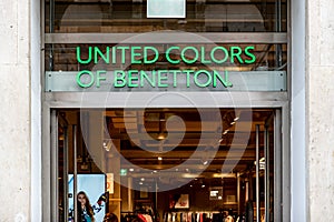 The green logo of United Colors of Benetton fashion store above the entrance