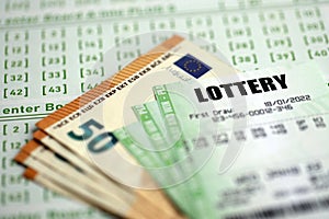 Green lottery tickets and euro money bills on blank with numbers for playing lottery