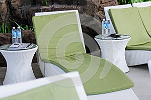 Green loungers by the pool at the luxury spa.