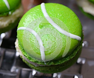 Green macarons hor` d`oeuvres filled with vanilla ice cream on crystal glass dish