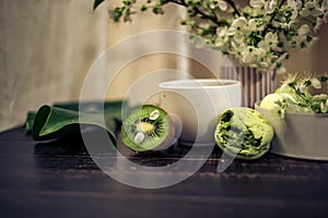 Green macarons on a wood table for coffee or a tea