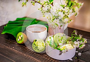 Green macarons on a wood table for coffee or a tea