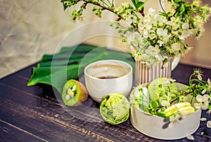 Green macarons on a wood table for coffee or a tea