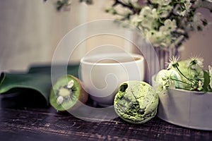 Green macarons on a wood table for coffee or a tea