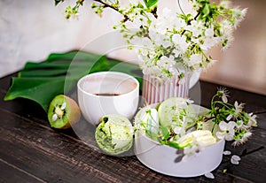 Green macarons on a wood table for coffee or a tea