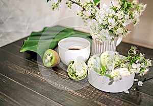 Green macarons on a wood table for coffee or a tea