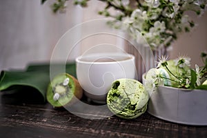 Green macarons on a wood table for coffee or a tea