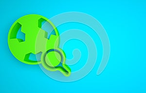 Green Magnifying glass with globe icon isolated on blue background. Analyzing the world. Global search sign. Minimalism