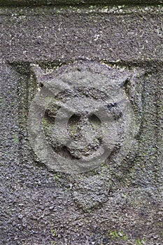 Green Man relief in stone on ancient pedestal