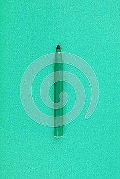 A green marker on a green cardboard