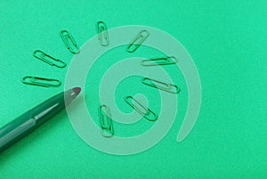 Green marker and paperclips