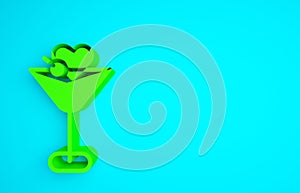 Green Martini glass icon isolated on blue background. Cocktail icon. Wine glass icon. Minimalism concept. 3d