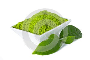 Green matcha tea powder with tealeaves on white