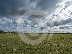 green meadow and blue sky with big clouds, Wisseler Duenen, Kalkar