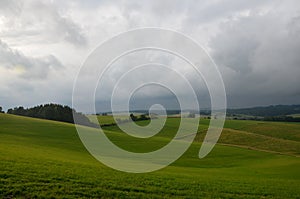 Green meadow with dramatic sky