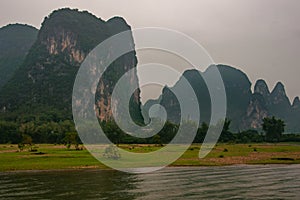 Green meadow and karst mountains along Li River in Guilin, China