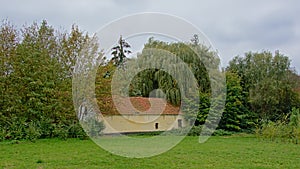 Meadow with old barn and trees in the Flemish countryside