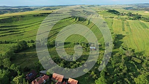 Green meadow in the spring, countryside hills from above, aerial view