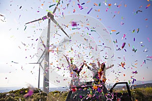 Green meadow with two wind turbine generating electricity