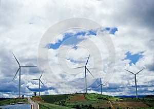 Green meadow with Wind turbines generating electricity