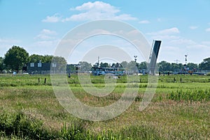 Green meadows with bicycle boat and the Male bridge, Malebrug, over the river Eem, between Amersfoort and Soest. Waiting