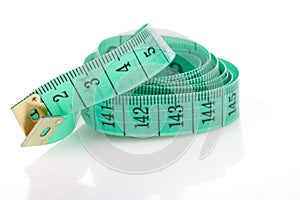 Green measuring tape, symbol of accuracy, on white