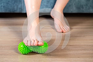 Green medical device for foot massage. Home physiotherapy. Close-up